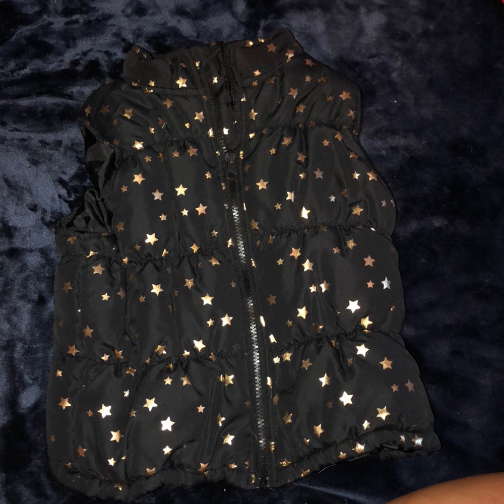 Black vest with gold stars